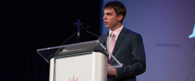 A Dayspring student talking in front of a podium at the Patriots Celebration Day